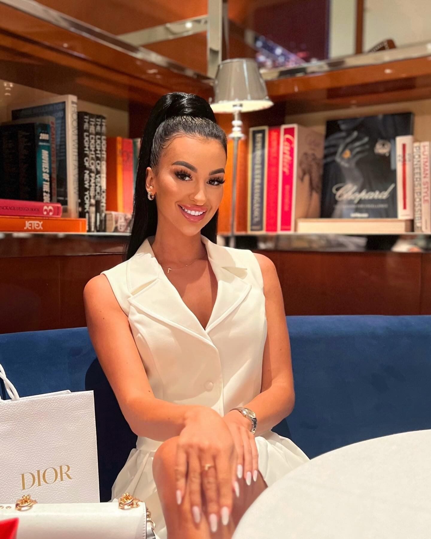 Anna, hair extension specialist, in a white dress